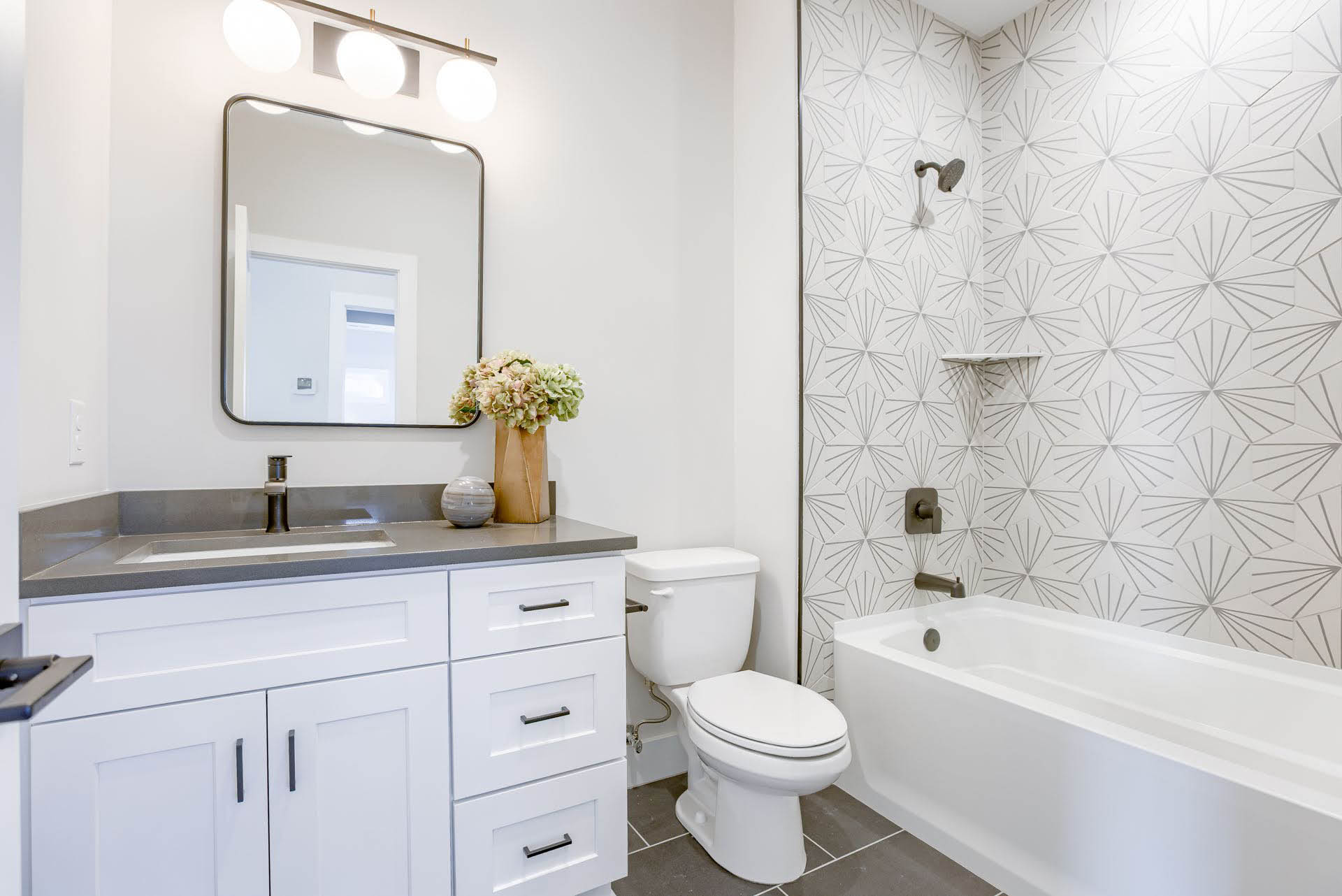 Full bathroom with patterned tile and tub | Coventry Ridge I | Kimberly Cahoy Design