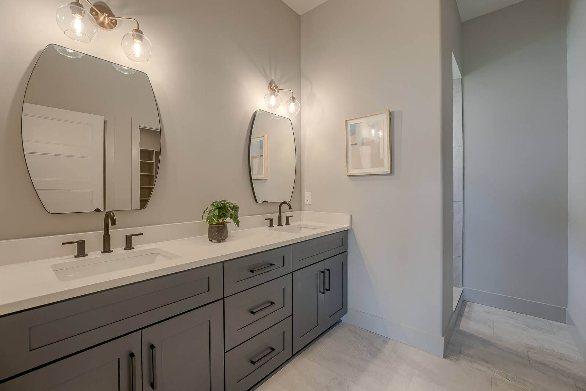 Primary bathroom with dark custom cabinetry and double sinks | Coventry Ridge II | Kimberly Cahoy Design